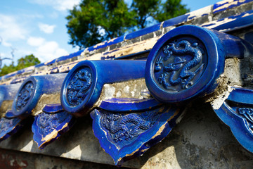 The blue glazed tiles on the wall as the background, the traditional architecture