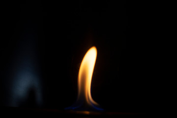 Tongue of fire flame in the dark. Ignition of oxygen in space. Fiery background. Fire of ether in the absence of light. Abstract fire heat background. Single fire. The ignition gel is on.