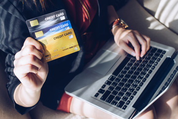 Close up of business woman holding credit card during using laptop for online shopping. Online shopping is the process of buying goods and services from merchants over the Internet.