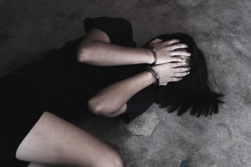 Kidnapped teen girl hands handcuffed. Abused and tortured concept. Human trafficking concept.