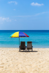 Relaxing on the beautiful beach under colorful umbrella, Holiday desitnation in South of Thailand, summer outdoor day light