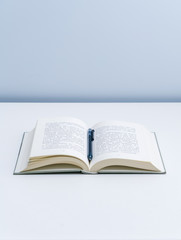 An open book on a white desktop