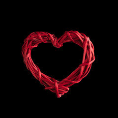 Valentine day concept. Wicker levitating red heart on black background. Greeeting card