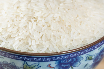 Rice served in blue and white porcelain bowl closeup.