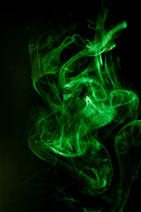 Fototapeta premium Green smoke motion on black background.