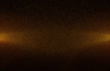 Glowing golden abstract bokeh glitter lights background of flickering gold particles and light flare