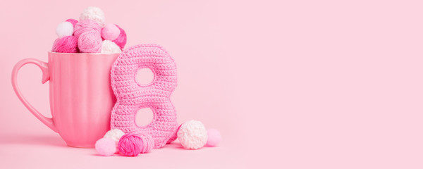 8 March symbol. Figure of eight made of handmade crochet. Happy womans day design. Decorative greeting grungy hobby card or postcard for international Woman's Day 8 March. Birthday for girl, banner