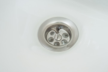 A whirlpool of water formed in the bathroom after opening the drain sewer.