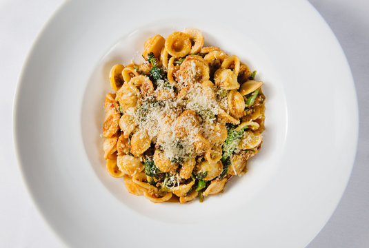 Italian pasta with tomato sauce, mixed greens and cheese