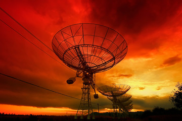 The silhouette of a radio telescope observatory