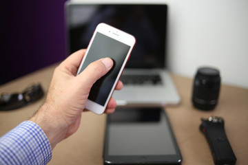 Audio, video and photography business office with equipment such as laptop, mobile phone, headphones and camera with photographic accessories