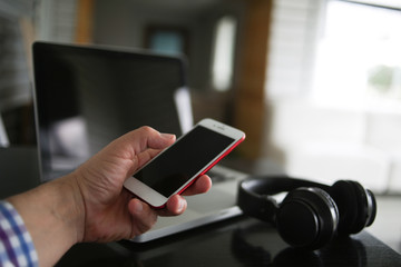 Audio, video and photography business office with equipment such as laptop, mobile phone, headphones and camera with photographic accessories