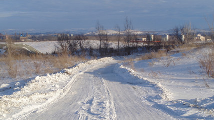 Winter road background. White snow. Country road. Ust-Kamenogorsk (Kazakhsan). City outskirts
