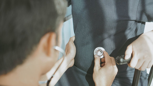 doctor uses a stethoscope to check the pregnancy.Happy young pregnant attractive woman, Sitting and look at the ultrasound pictures, touching her belly ,pregnancy expectation concept.
