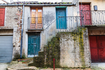 Obraz na płótnie Canvas Italy, Sicily, Palermo Province, Geraci Siculo. Apartment building with colorful doors in the town of Geraci Siculo.