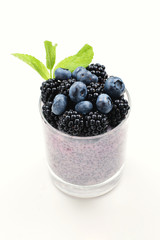 Chia pudding with mint, blueberry, blackberry on a white background. Space for text or design.