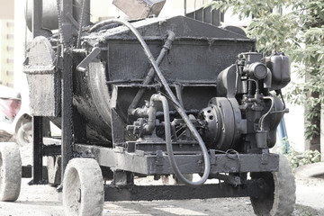Fototapeta na wymiar Bitumen Bituminous Asphalt Mixer Coal Tar Dispensing Hydraulic Machine Or Automatic Mixture Machinery Or Equipment For Road Construction