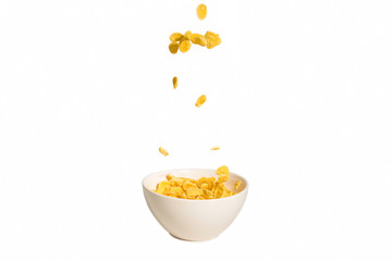 Corn flakes falling to the white bowl. Motion.