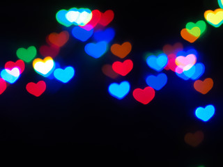 Colorful heart shaped bokeh on black background. Concept valentine's day,love,anniversary..