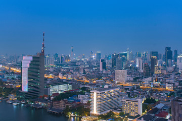 Bangkok city skyline in downtown district at night blue hour time.