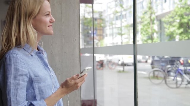 Happy businesswoman making phone call in coffee shop