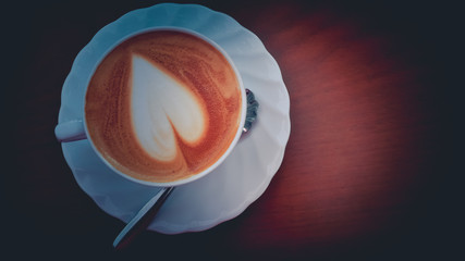 Close up Coffee heart shape in white cup.