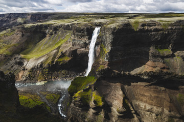 Aerial view of Haifoss big waterfall in south Iceland. Black high rocks, green hills and nobody...