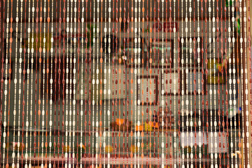 Italy, Sicily, Trapani Province, Erice. Beaded curtain at the entrance to a shop in the hill town...