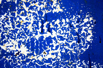 Abstract background of peeling white paint on a blue wall, rust on a cold wall