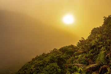 Beautiful sunset in foggy mountains landscape