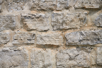 Fragment of an old masonry. Natural stone limestone.