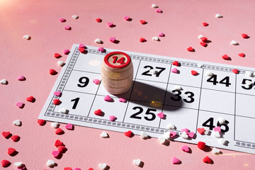Lotto ticket with wood barrel 14 number on pink hearts background. Valentines day 14 february minimal concept.
