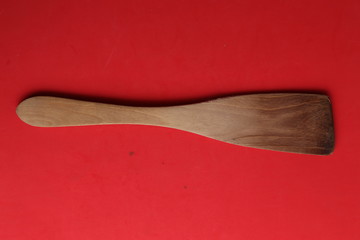 wooden cooking spatula in color background