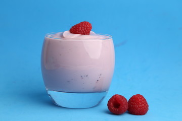 delicious raspberry yogurt in color background