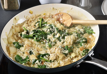 Greek spanakorizo simmering in a pot