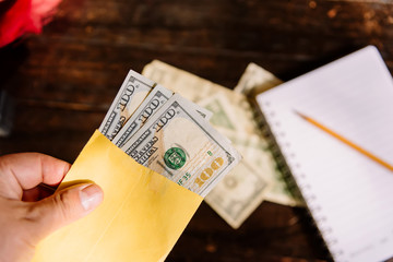 Bills on a wooden table, counting money