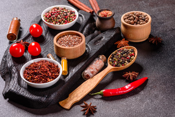 Spices and herbs over black stone background. Top view with free space for menu or recipes