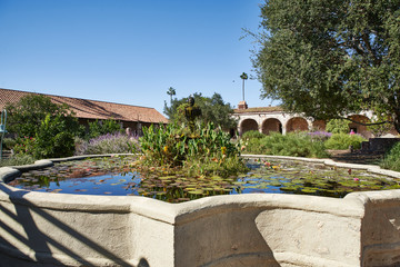 Pound and trees in the Court Yard in a Historic Spanish Mission Church in California During the Day