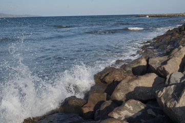 Sea waves running on stones, summer vacation.