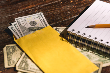 Budget - Bills on a wooden table, counting money