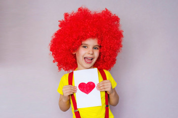 Happy Valentine's Day. Let's celebrate! Funny baby clown playing at home. April 1 concept of April...