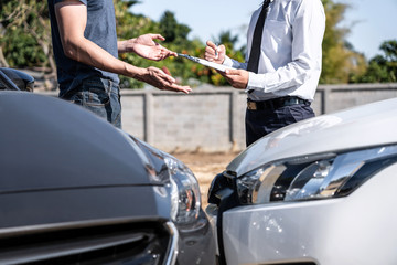 Insurance Agent examining car crash and customer assessed negotiation, checking and signing on report claim form process after accident collision, Accident and insurance concept