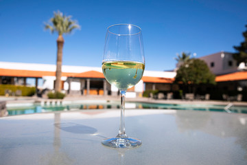 Wine glass in a beautiful hotel with pool