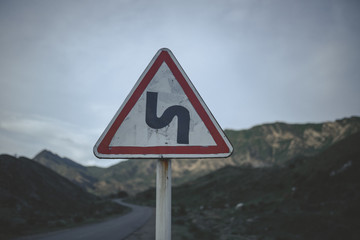 Landscape with mountains, clouds, water, and roads in a Central Asian country