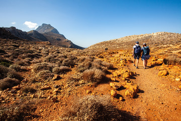 Balos lagoon on Crete island, Greece. Tourists relax and bath in crystal clear water of Balos beach. The most unique natural attraction in Crete.