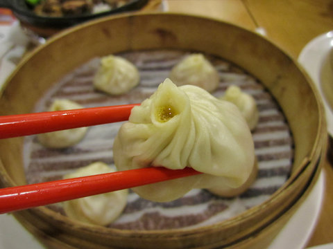 Chopsticks Holding a Hot Soup Dumpling ("Xiao Long Bao")