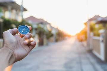 man holding compass on blurred background. for activity lifestyle outdoors freedom or travel tourism and inspiration backpacker alone tourist travel or navigator image.