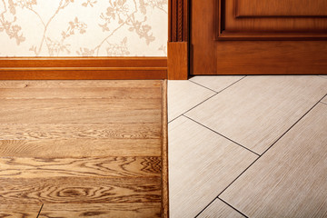 Floor covering and ceramic tiles and wooden parquet. Joint.