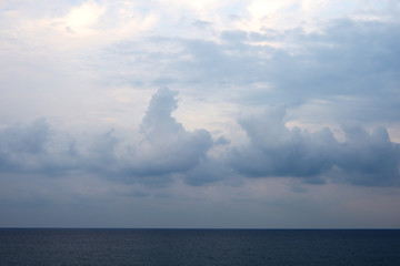 Overcast sky over the sea on a summer evening near the coast of Sicily. Natural background