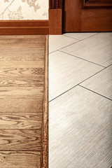 Floor covering and ceramic tiles and wooden parquet. Joint.